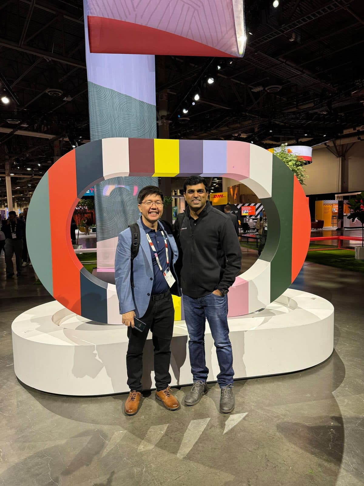 Baig Mohammed with a fellow attendee on the Oracle AI World show floor